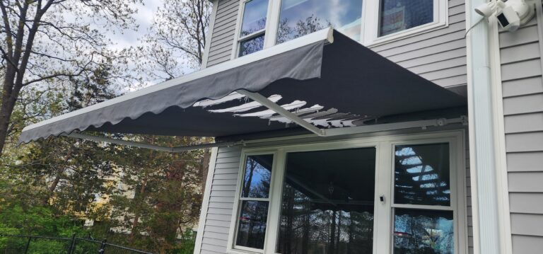 Squirrel damage to a regular awning showcasing the benefits of full cassette retractable awnings
